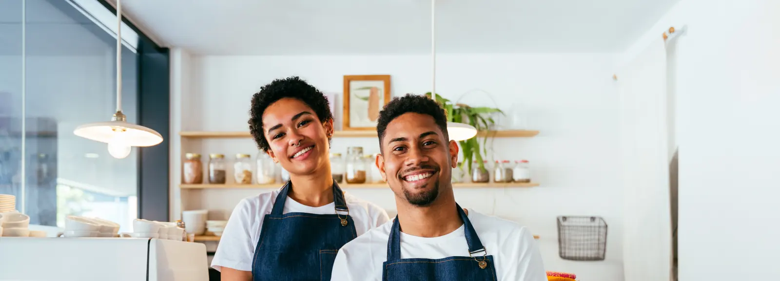 Barista and waiter working in a café