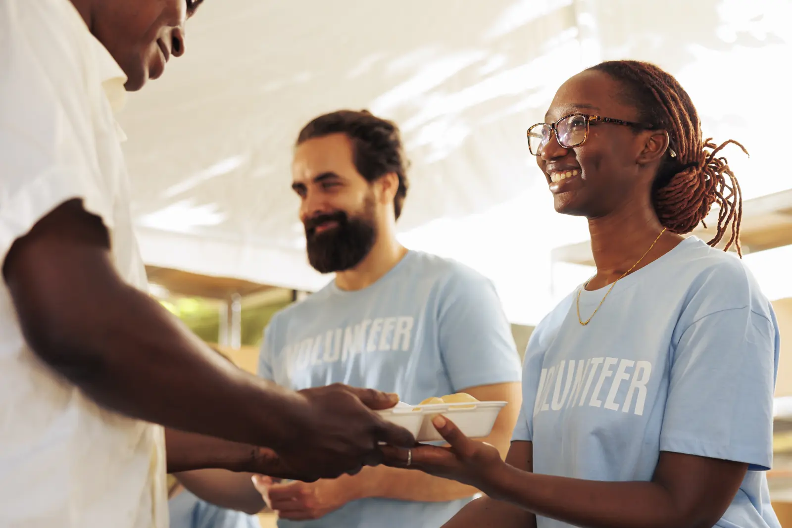 Volunteers serving meals together